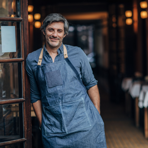 A Man Standing In Font Of Cafe