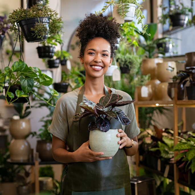 Happy Woman With Plant